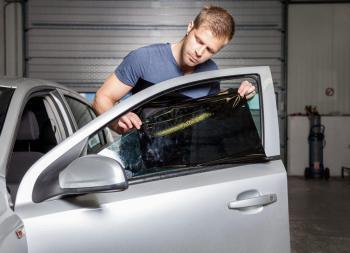 Man using vinyl on car window