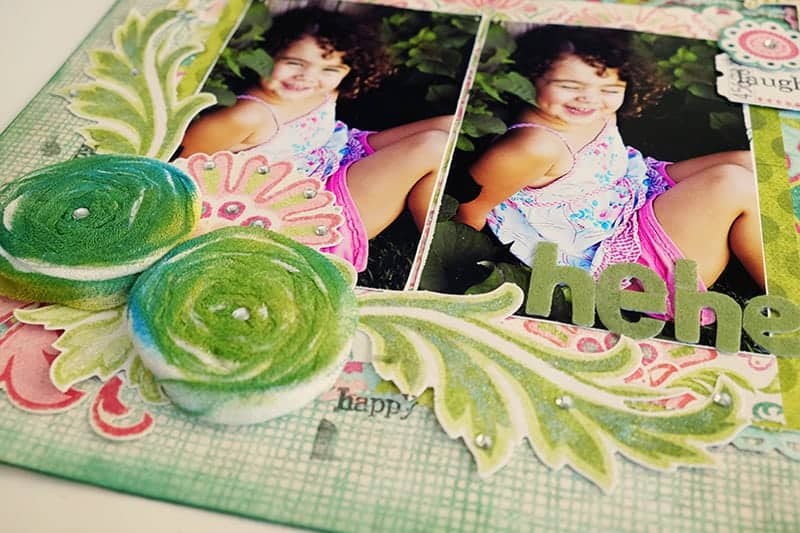 Embellishments on bottom of die cut scrapbook page