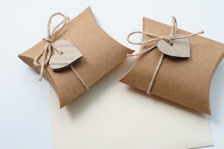 Two Small Handmade gift boxes with kraft paper with heart on white