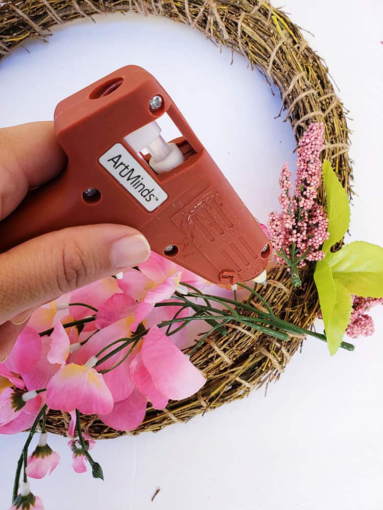 Gluing-flowers-to-Easter-wreath