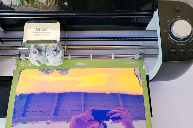 Use Cricut machine to cut design in adhesive vinyl
