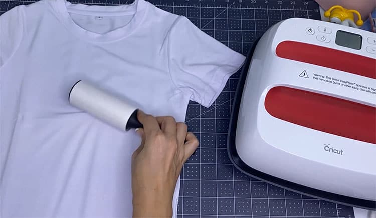Use lint roller to prepare shirt 