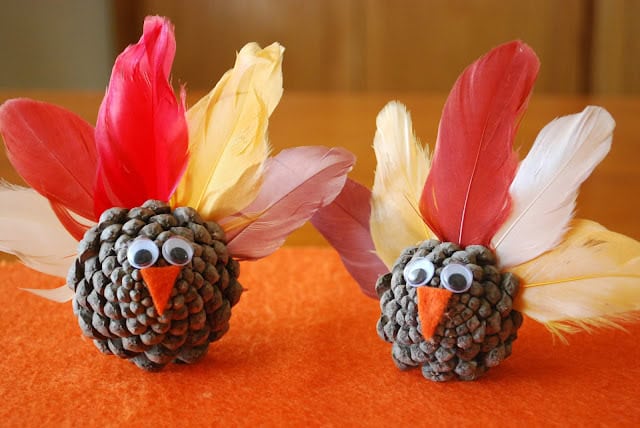 Thanksgiving Pinecone Turkeys by a pumpkin and a princess