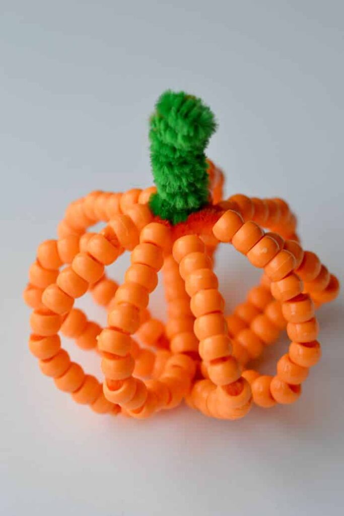Beaded Pumpkin Craft for Kids by glue sticks gum drops