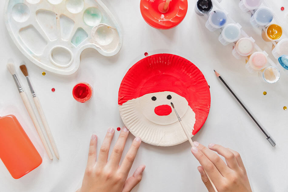 Painting santa eye and nose on paper plate