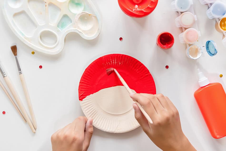 Painting santa hat on paper plate